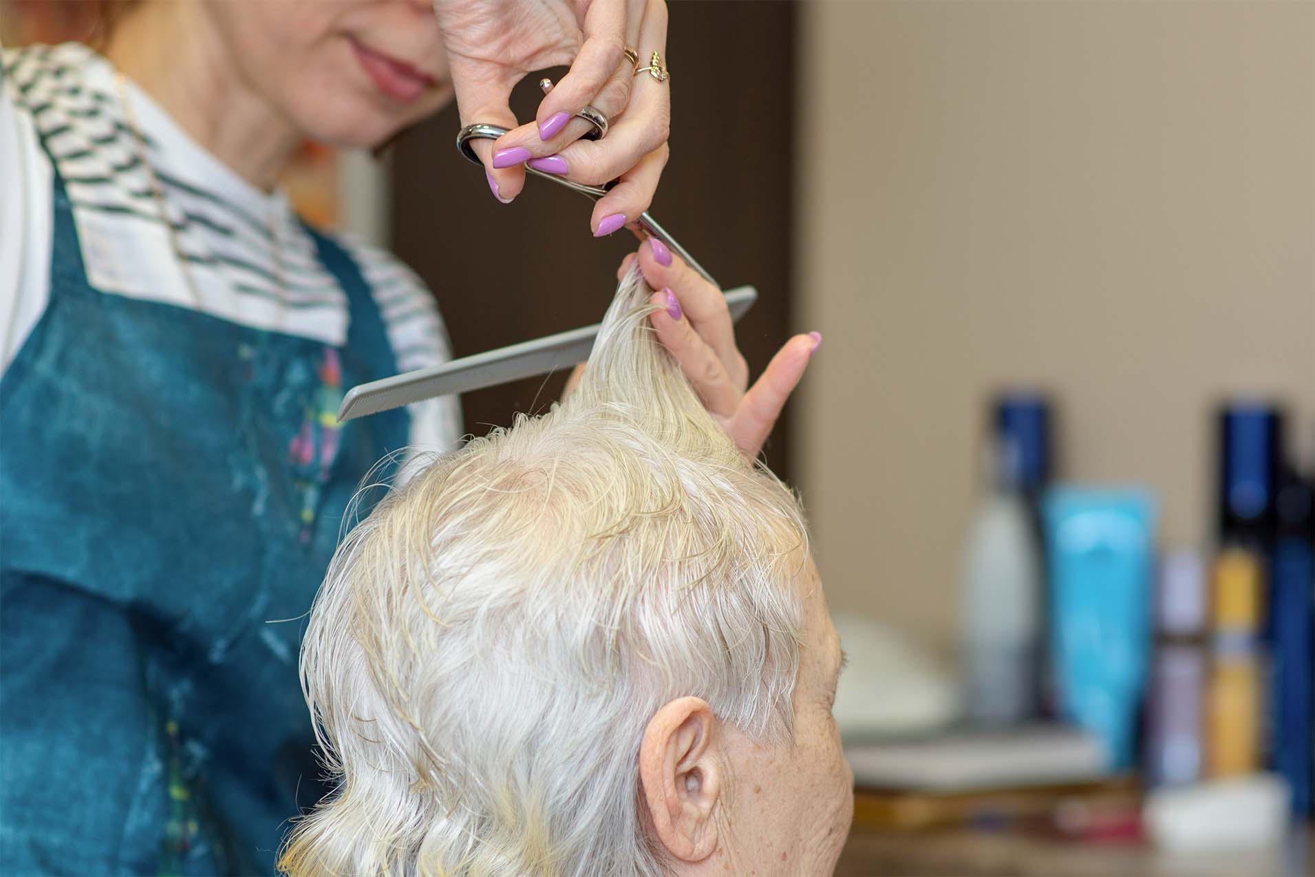 hairdresser cutting residents hair
