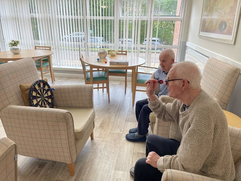 residents playing darts together