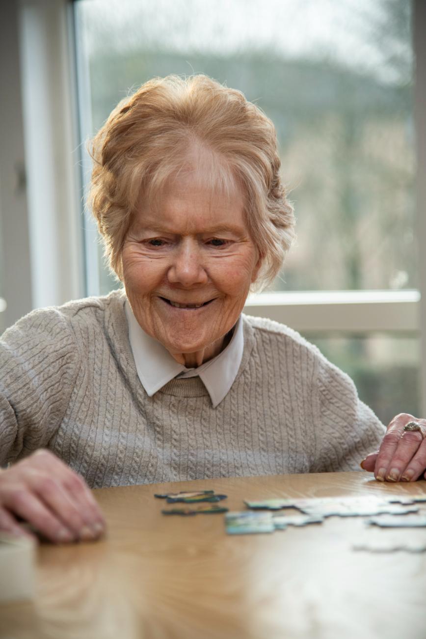 Female resident doing a jigsaw puzzle