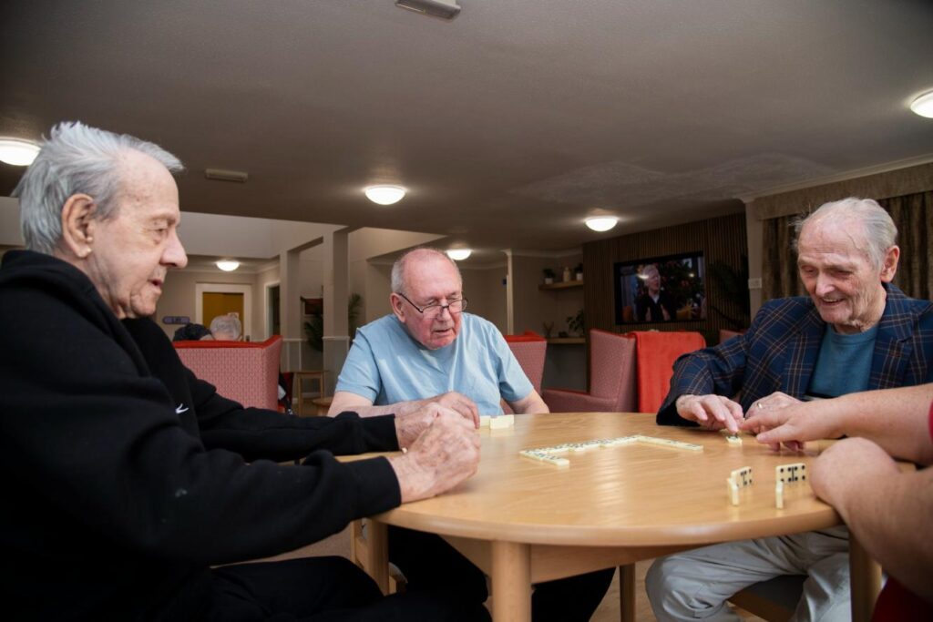 Residents playing a hame of dominoes at Campsie View Care Home
