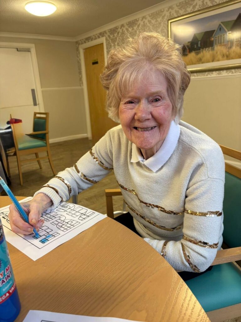 Resident doing arts and crafts