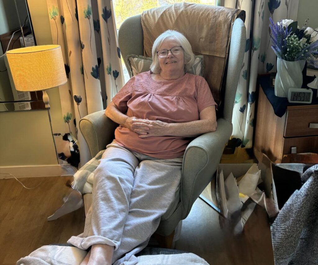 donna relaxing in an armchair at campsie view care home