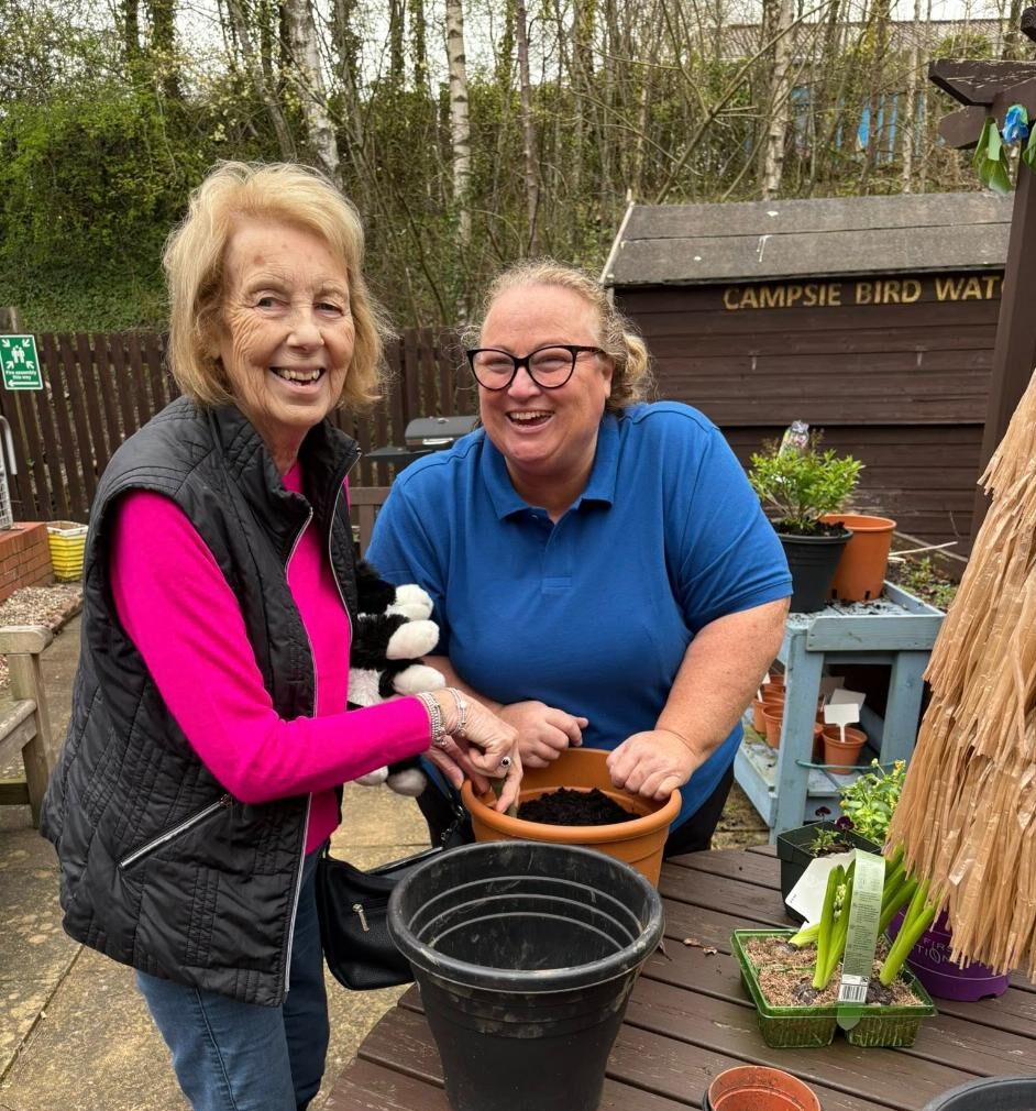 resident and staff in a gardening club