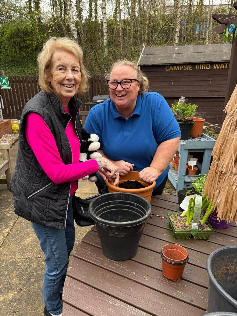 resident and staff in a gardening club