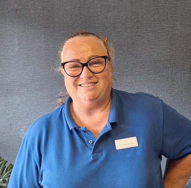 woman smiling in blue polo shirt