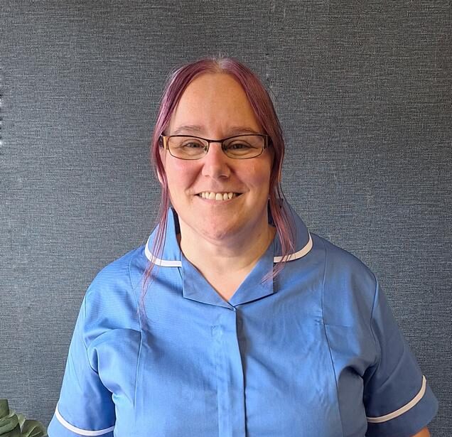 woman in blue care home uniform